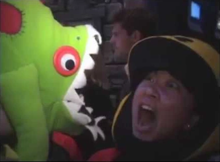 A bright green plush murloc and a delighted convention-goer in the live-action E3 film